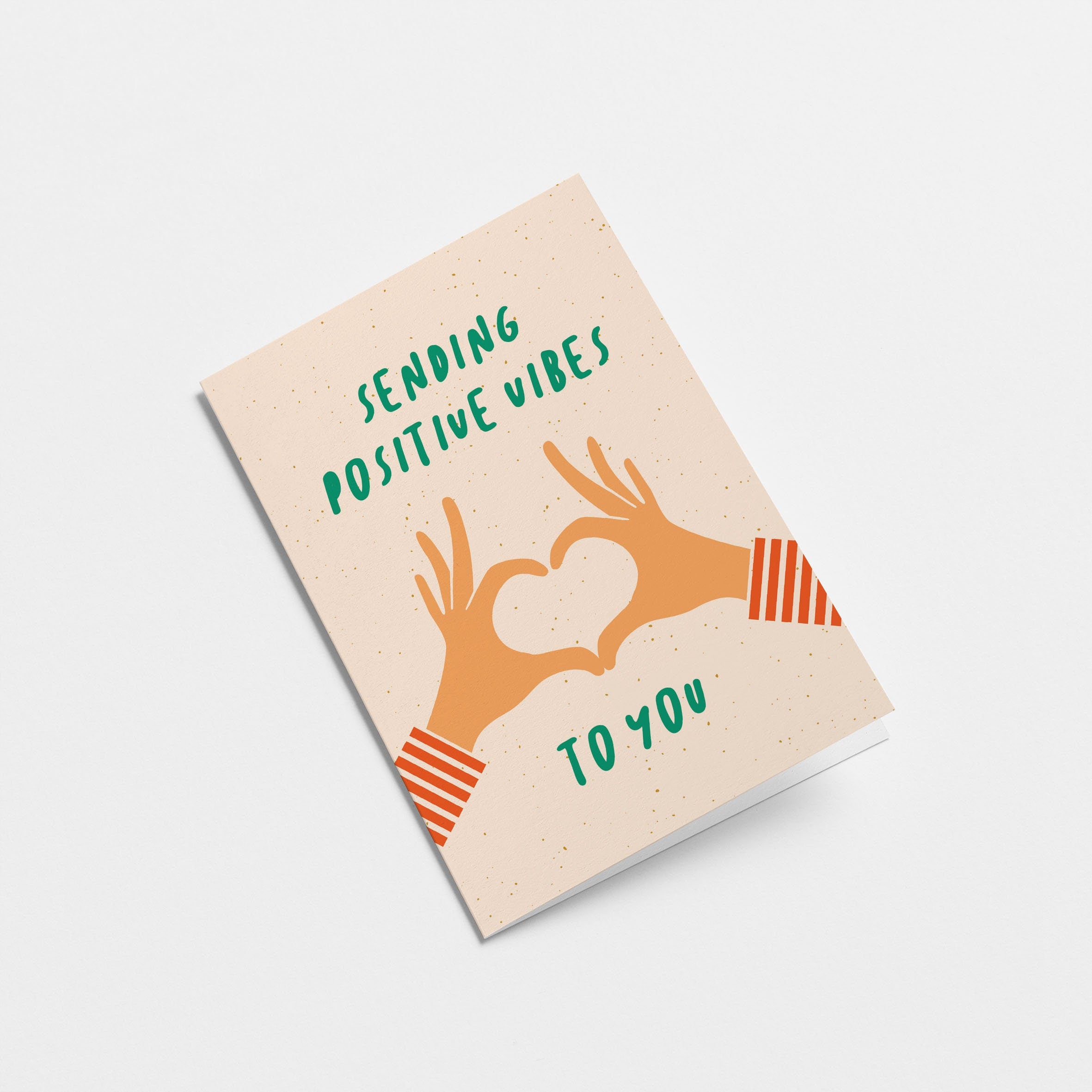 greeting card with two hands creating heart shape with fingers and a text that says sending positive vibes to you