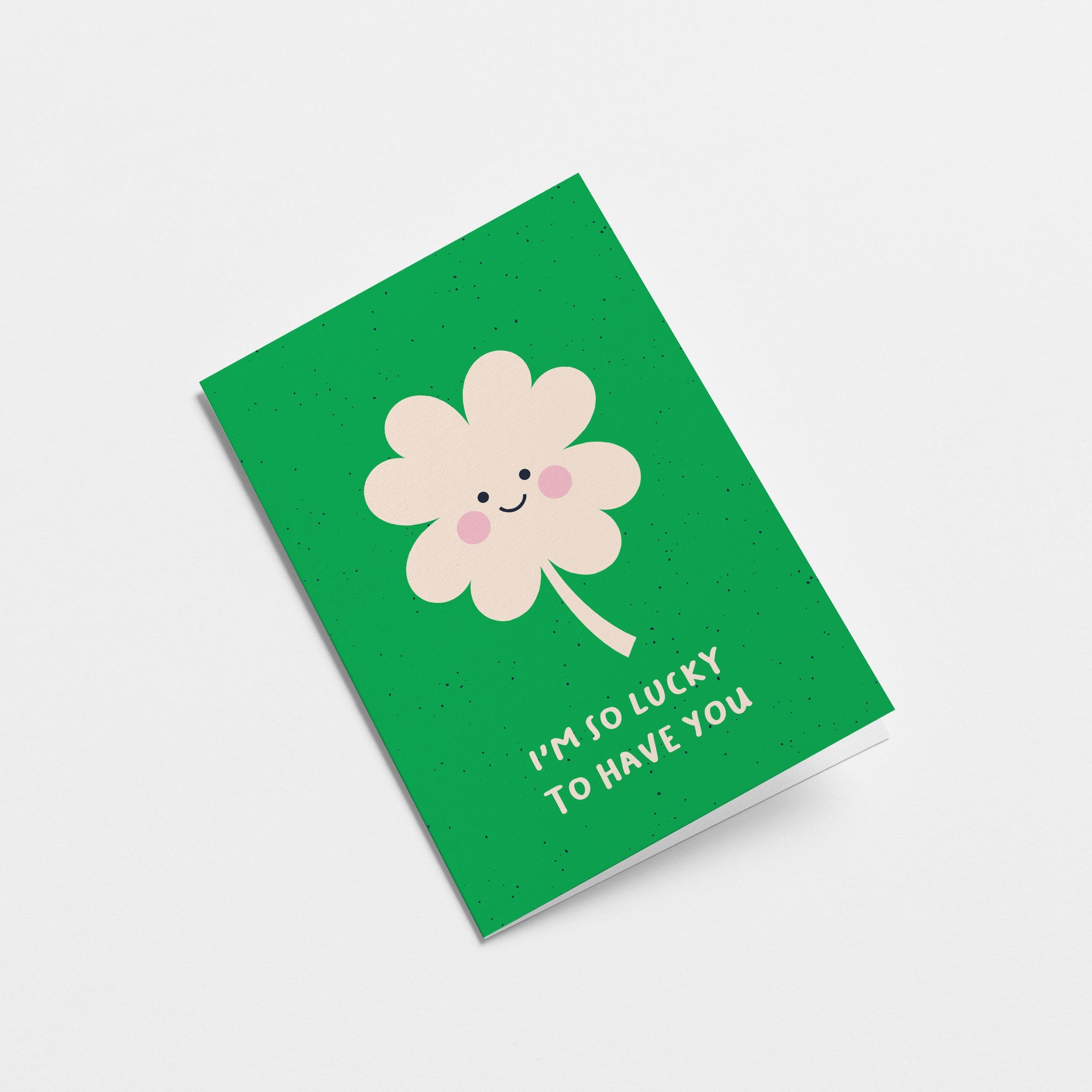 Love card with a white clover with a smiley face and a text that says i’m so lucky to have you