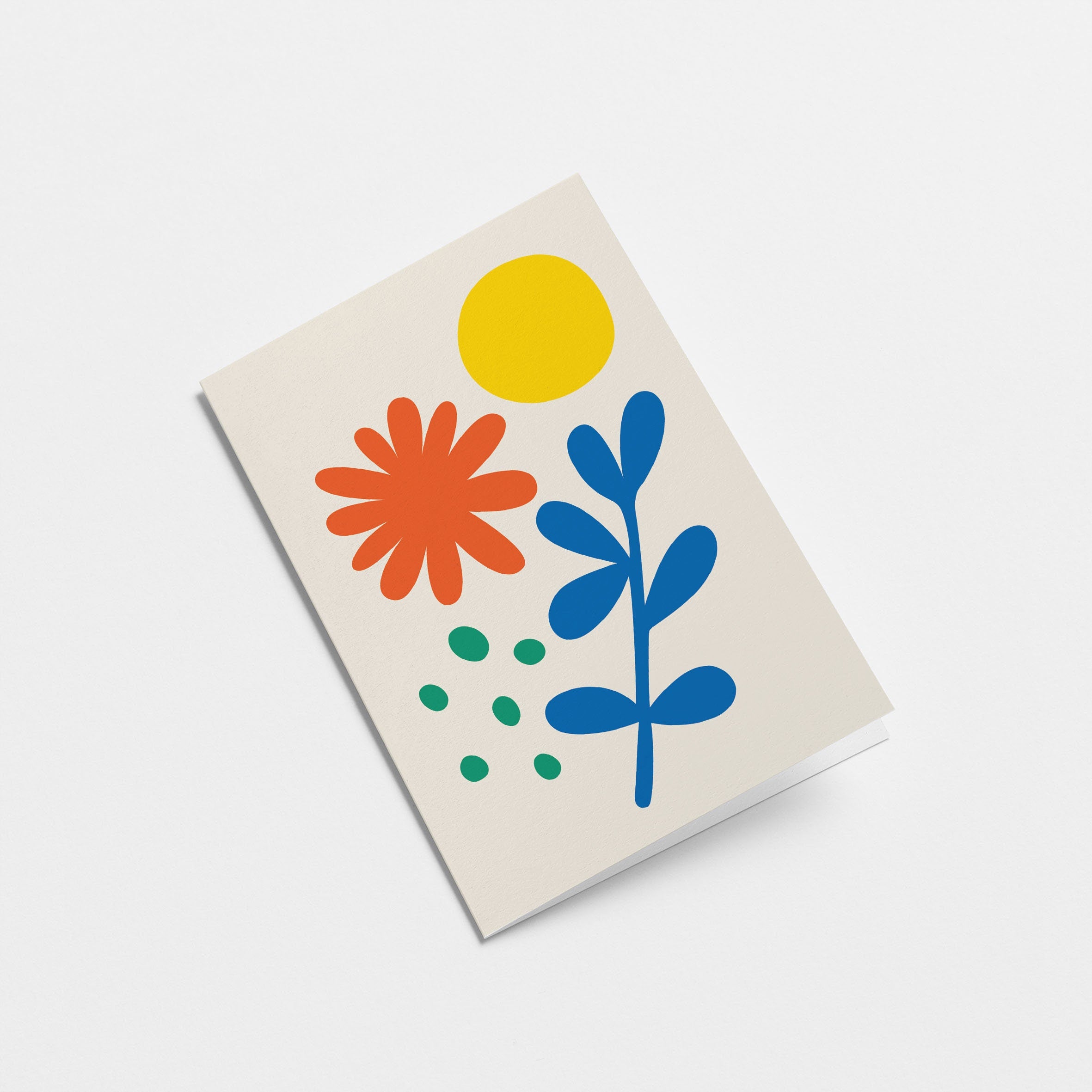 greeting card with red and blue flower, green dots and yellow sun