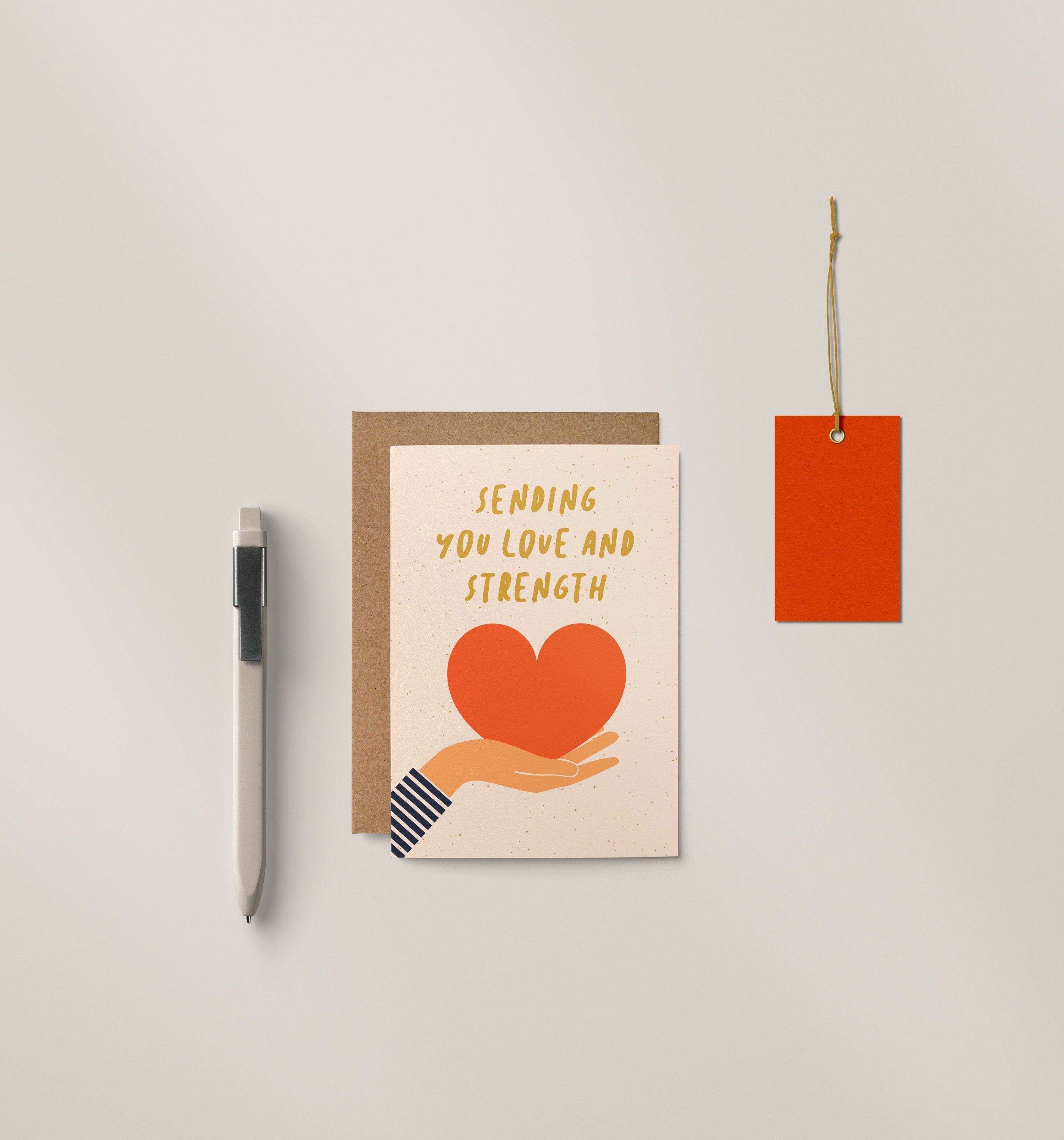 Sympathy card with a hand holding a red heart and text that says sending you Love and strength