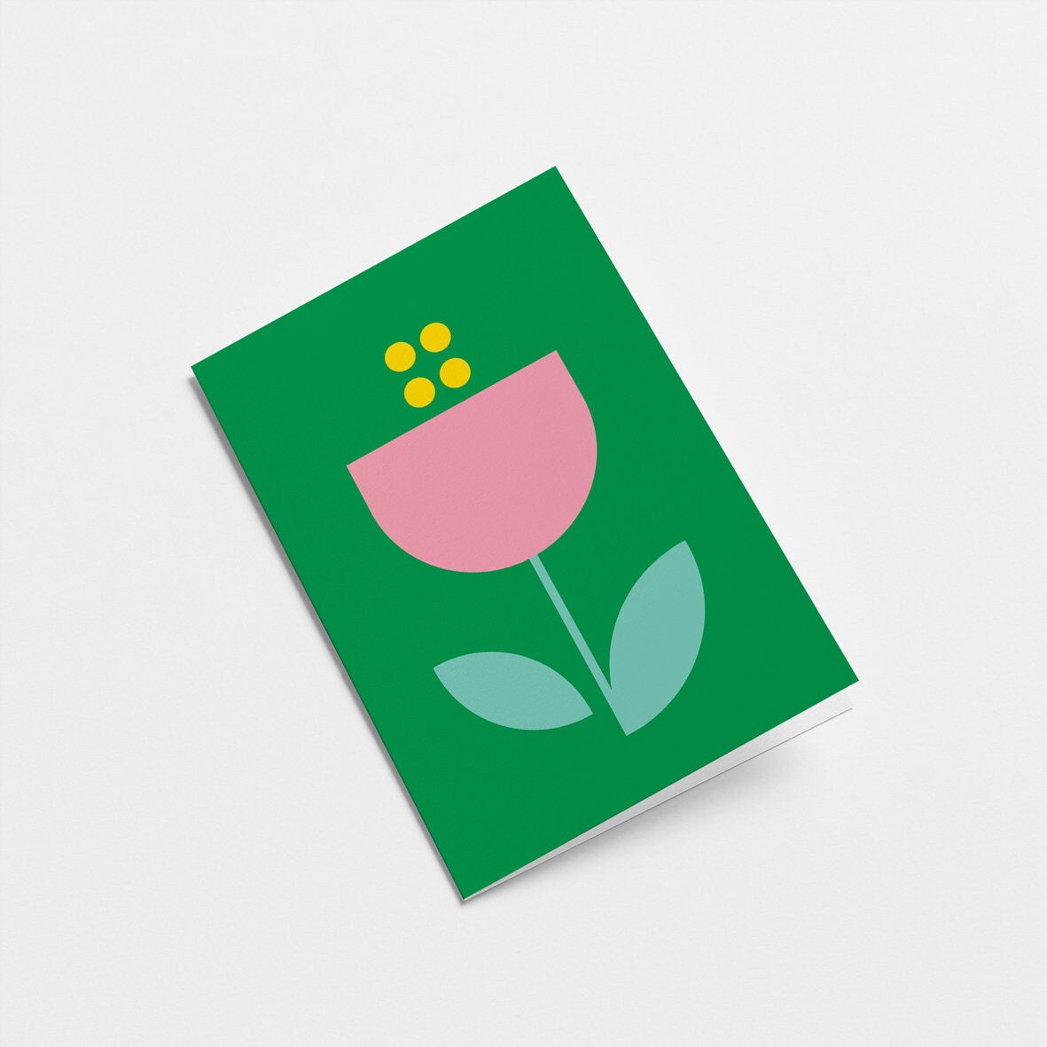 everyday greeting card with a green background and pink flower with blue leafs